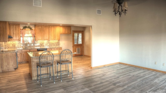 kitchen with tasteful backsplash, ceiling fan, sink, and hardwood / wood-style flooring