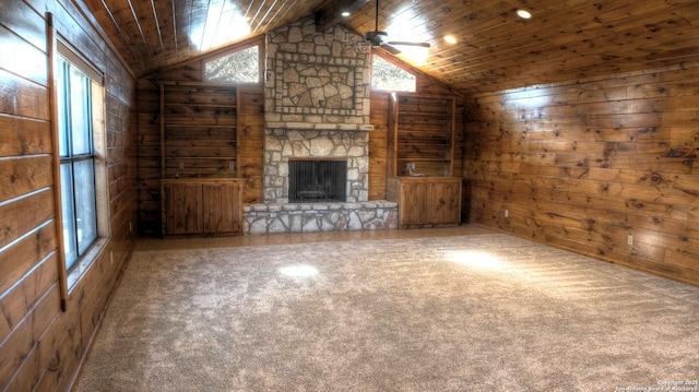 unfurnished living room featuring wooden ceiling, a healthy amount of sunlight, and wood walls