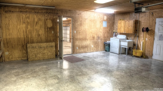 basement with washer / clothes dryer, wood ceiling, and wooden walls