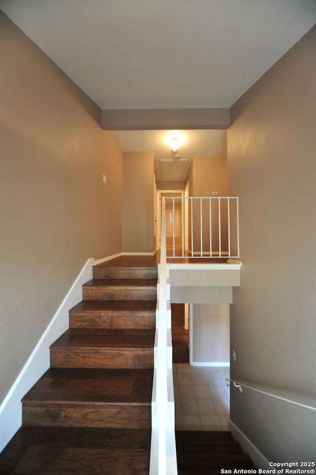 stairs featuring tile patterned flooring