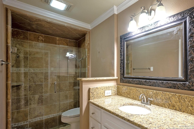 bathroom with vanity, toilet, ornamental molding, and walk in shower