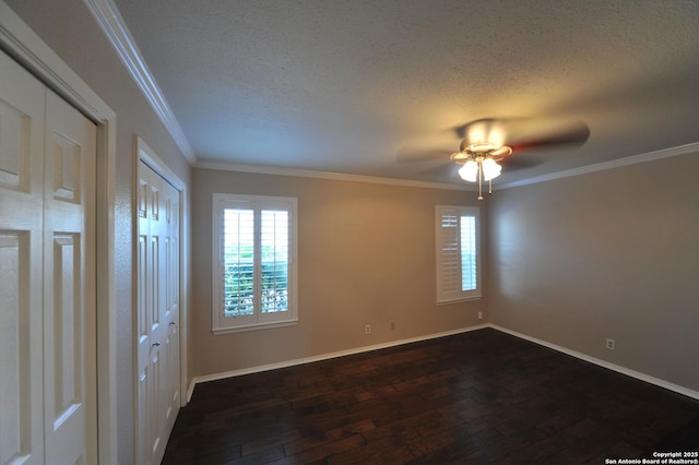 unfurnished bedroom featuring ceiling fan, a textured ceiling, dark hardwood / wood-style flooring, and ornamental molding