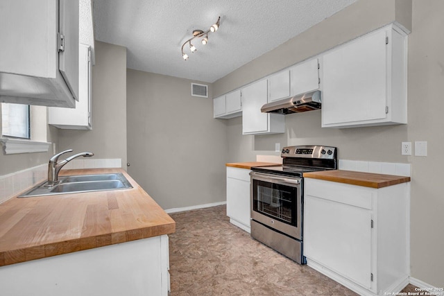 kitchen with stainless steel range with electric stovetop, track lighting, a textured ceiling, white cabinets, and sink