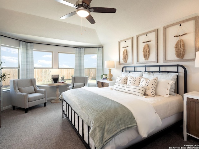 carpeted bedroom with ceiling fan, multiple windows, and lofted ceiling