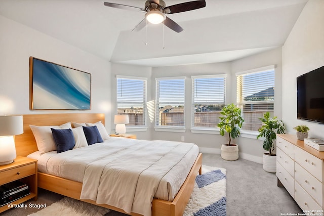 carpeted bedroom featuring ceiling fan and lofted ceiling