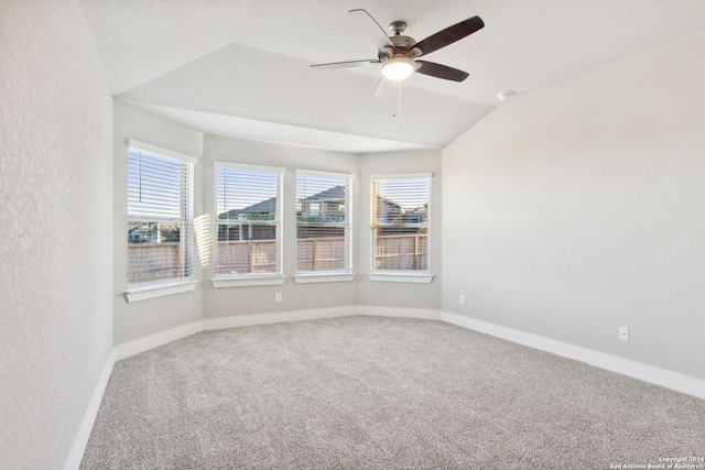 carpeted empty room with ceiling fan and lofted ceiling