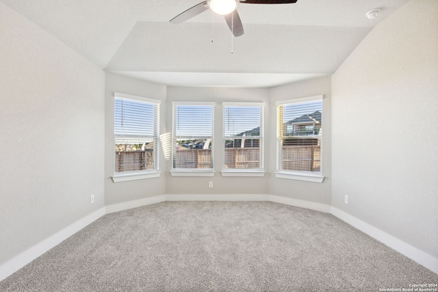 empty room featuring ceiling fan, lofted ceiling, and carpet floors