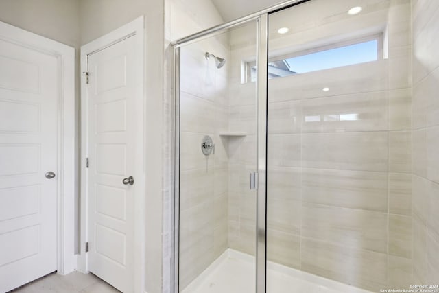 bathroom with a shower with shower door