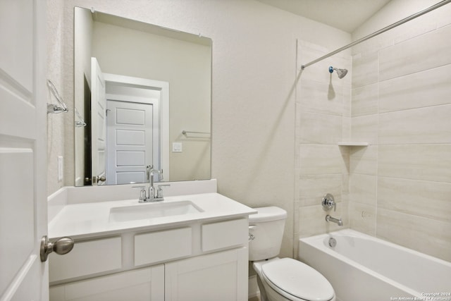 full bathroom featuring toilet, tiled shower / bath combo, and vanity