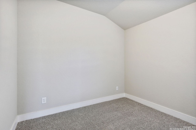 spare room with lofted ceiling and carpet