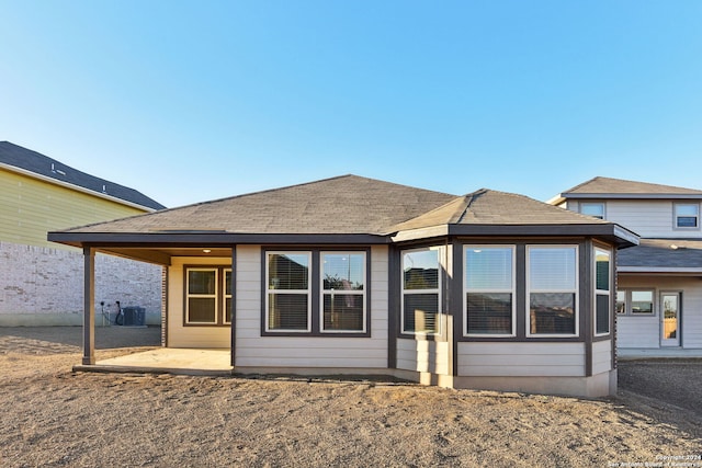 rear view of property featuring central AC unit and a patio