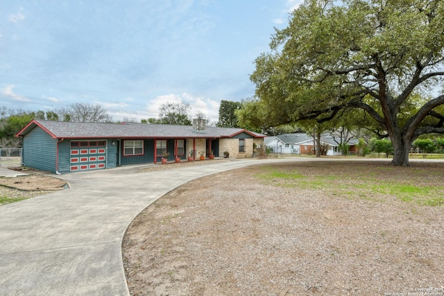 ranch-style house with driveway and an attached garage