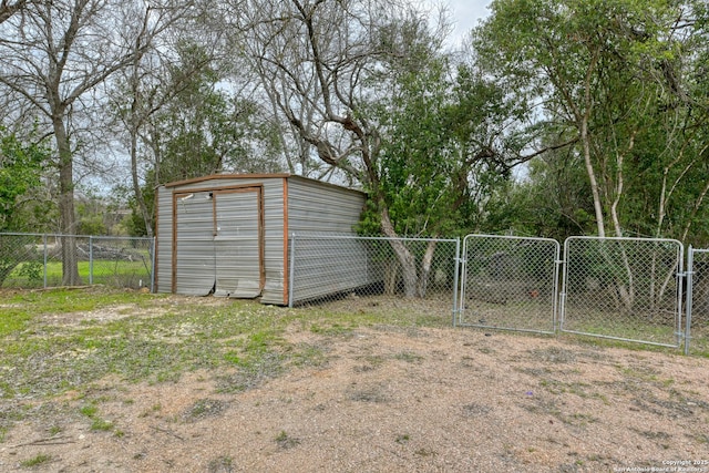 view of shed with fence and a gate