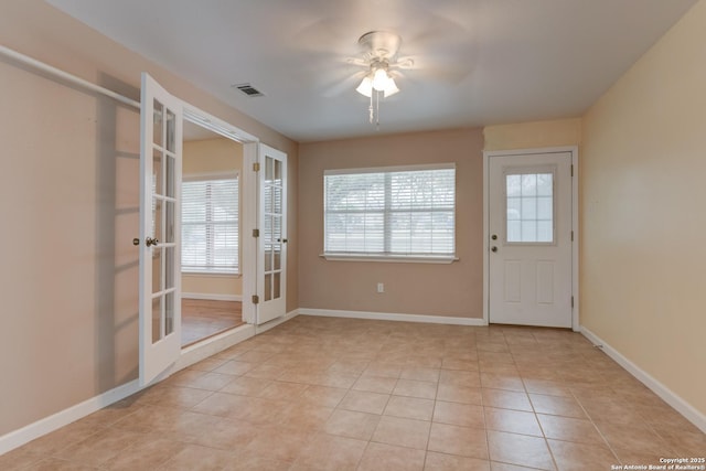 doorway to outside featuring french doors, light tile patterned flooring, visible vents, and baseboards