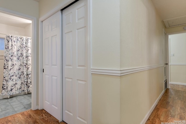 hall featuring baseboards and wood finished floors