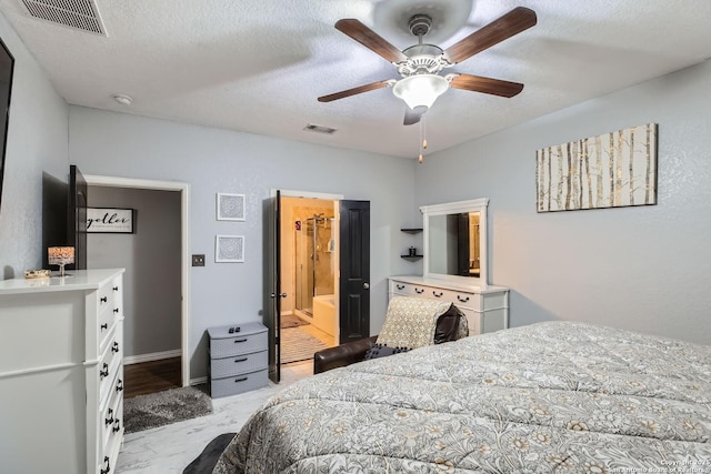 bedroom featuring a textured ceiling, ceiling fan, and ensuite bath