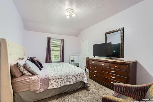 bedroom featuring lofted ceiling, a textured ceiling, and carpet flooring