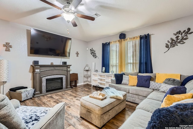 living room featuring ceiling fan and hardwood / wood-style floors