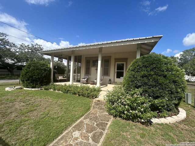 rear view of house with a lawn and a patio