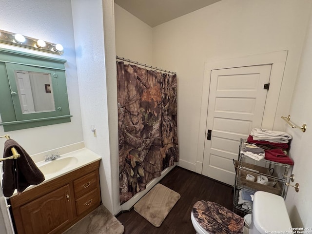 bathroom with toilet, walk in shower, wood-type flooring, and vanity