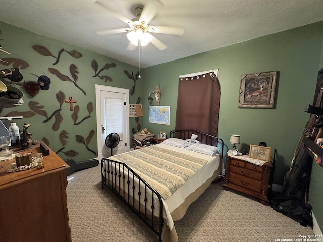 bedroom featuring a textured ceiling, ceiling fan, and light colored carpet