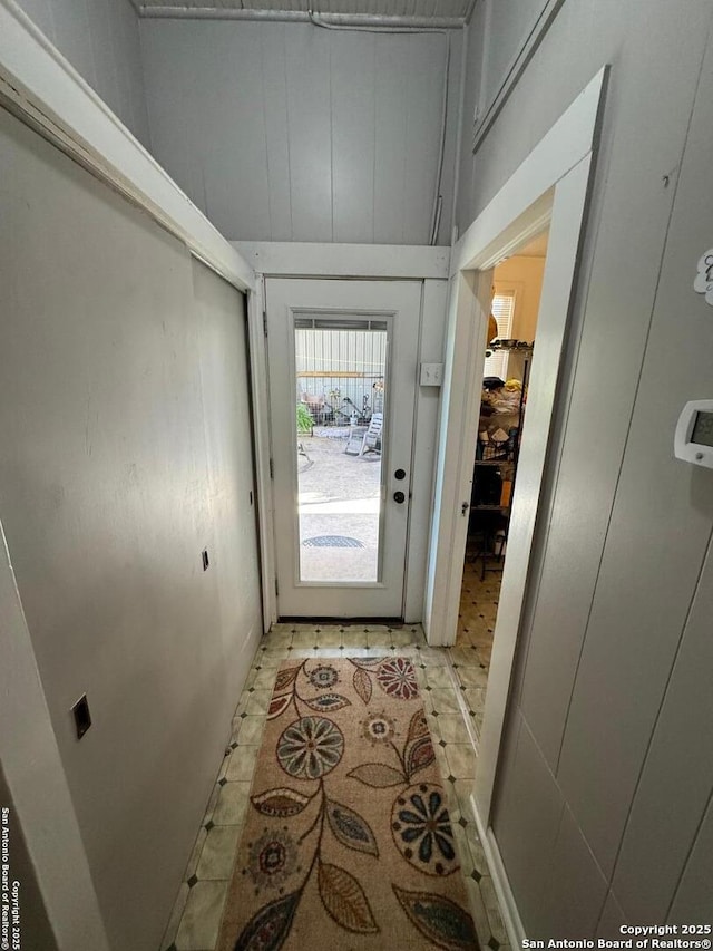 doorway to outside with light tile patterned flooring