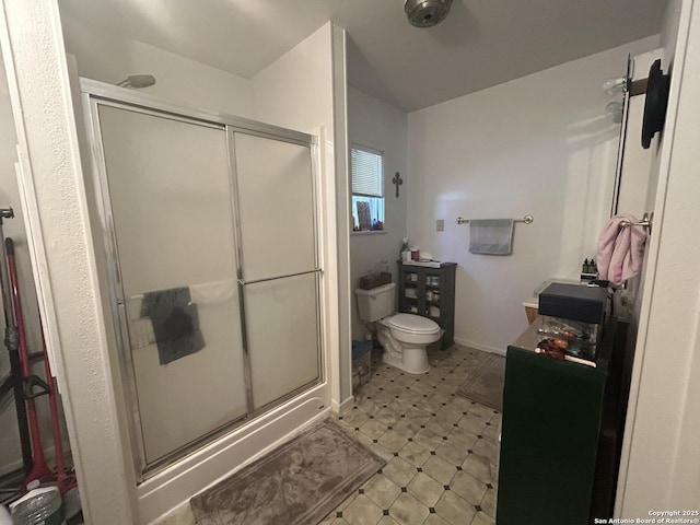 bathroom featuring an enclosed shower and toilet