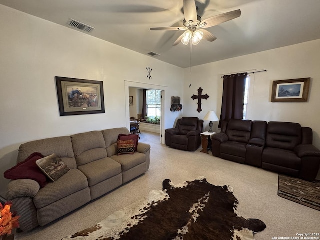 carpeted living room featuring ceiling fan