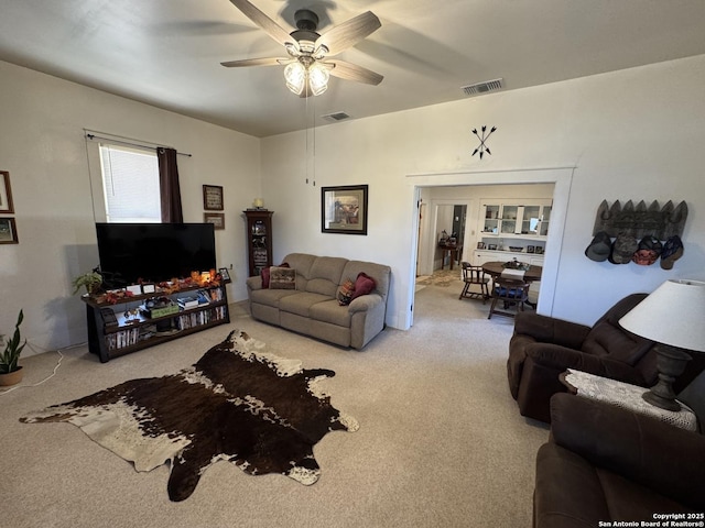 living room featuring carpet floors and ceiling fan