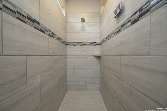 bathroom with tiled shower