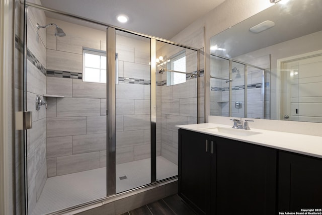 bathroom with vanity and a shower with door