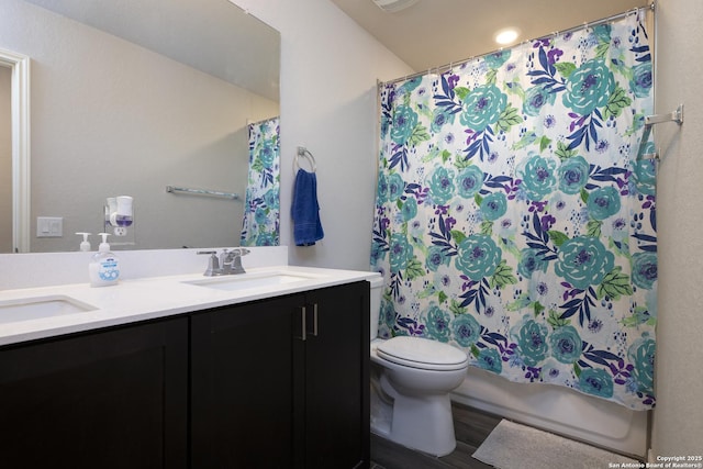 bathroom featuring toilet, hardwood / wood-style flooring, and vanity