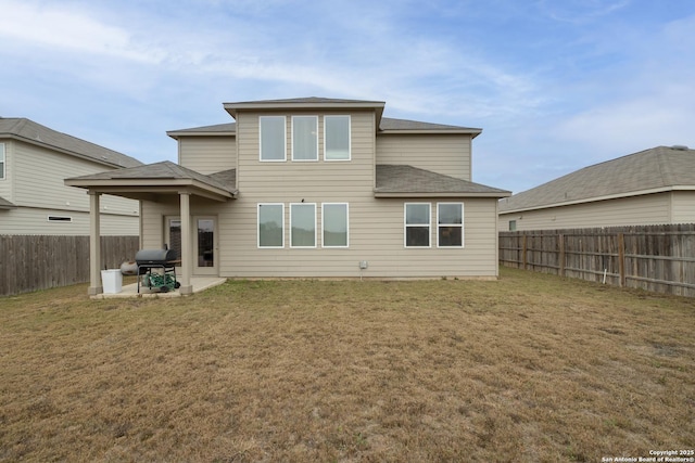 rear view of property with a patio area and a yard