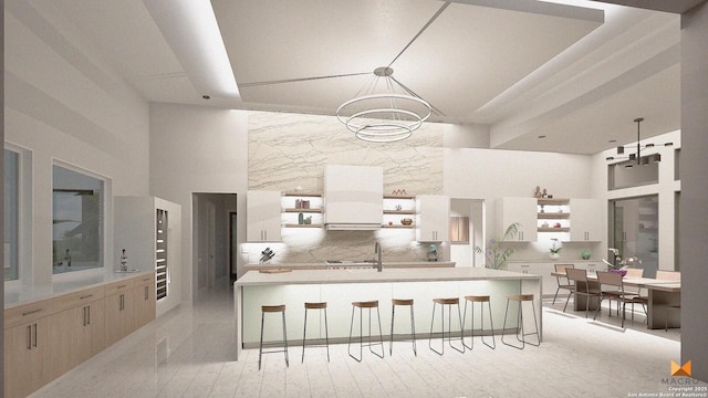 kitchen with hanging light fixtures, a kitchen breakfast bar, and a high ceiling