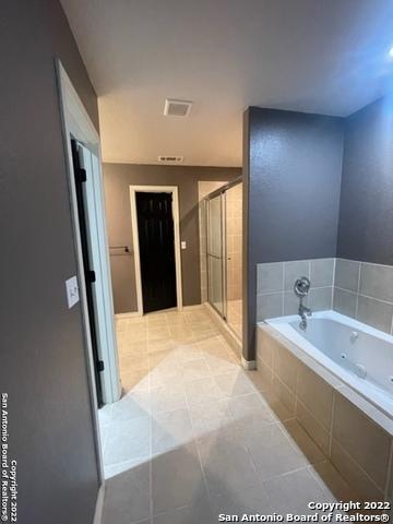 bathroom with plus walk in shower and tile patterned floors