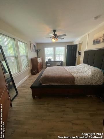 bedroom featuring ceiling fan and dark hardwood / wood-style floors