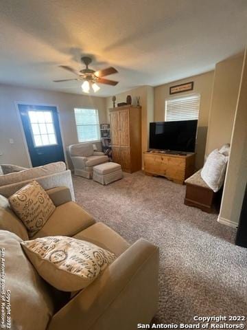 carpeted living room featuring ceiling fan