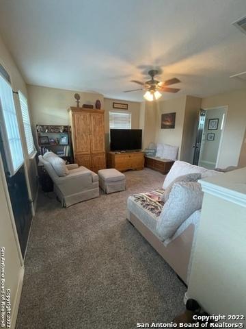 bedroom featuring ceiling fan and dark colored carpet