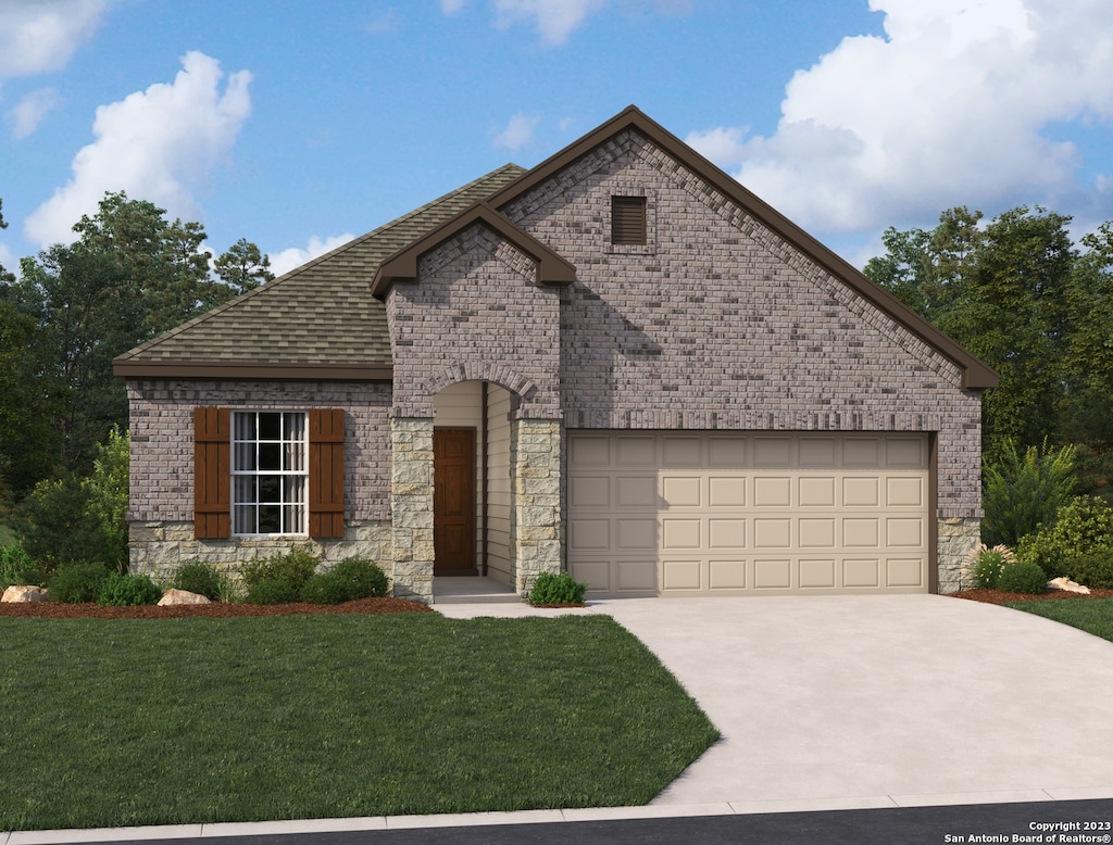 view of front of home featuring a garage and a front yard