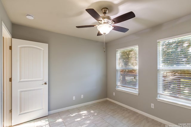 unfurnished room with ceiling fan