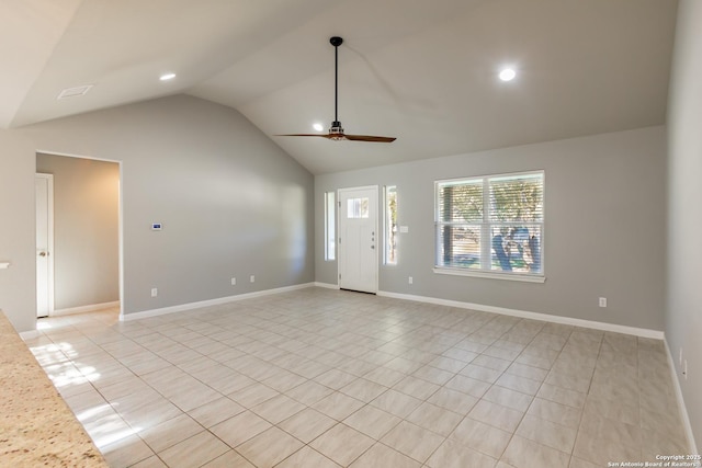 unfurnished living room featuring ceiling fan, light tile patterned floors, and vaulted ceiling