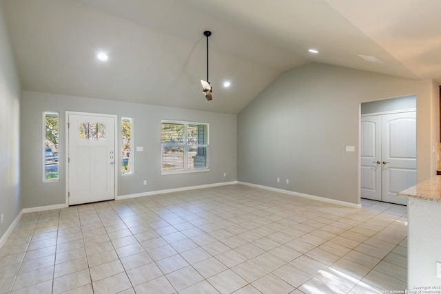 tiled foyer entrance with lofted ceiling