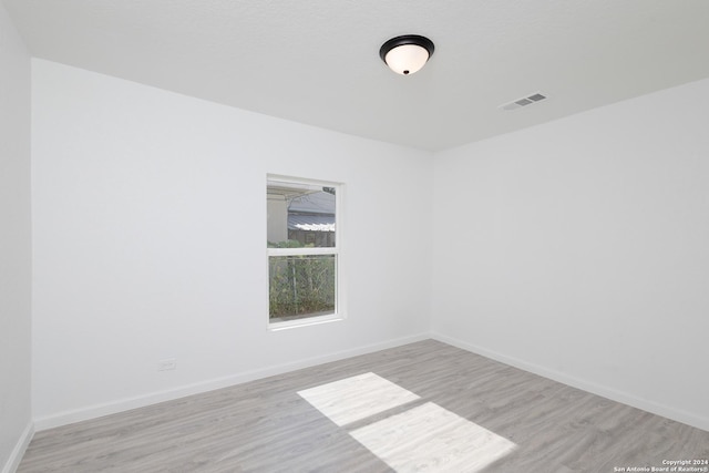 unfurnished room featuring light hardwood / wood-style floors