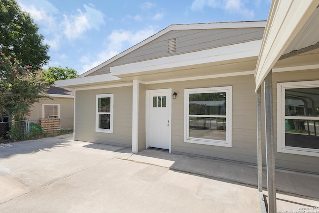 property entrance featuring a patio area