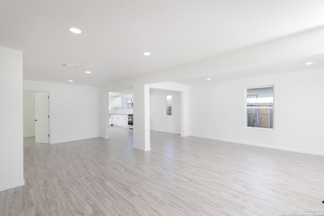 unfurnished living room with light wood-type flooring