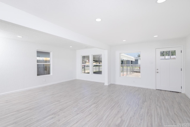 unfurnished living room featuring light wood-type flooring