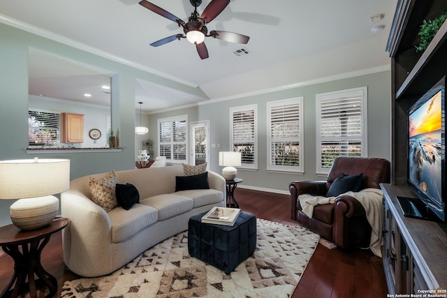 living room with wood-type flooring, ornamental molding, and ceiling fan