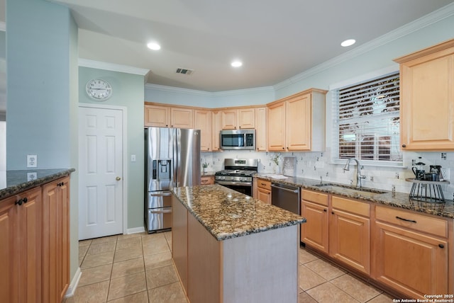 kitchen with sink, light tile patterned floors, stainless steel appliances, a center island, and dark stone counters