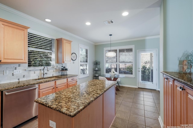 kitchen with sink, hanging light fixtures, dishwasher, a kitchen island, and dark stone counters