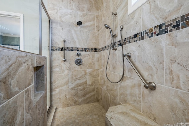 bathroom with a tile shower